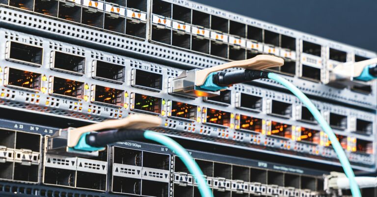 Fiber-optic cables connected to an enterprise network switch